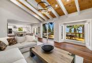 Gorgeous living room wtih vaulted ceilings and lake views