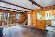 Living Area with Gas Fireplace and Original Hardwood Floors