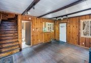 Living Area with Gas Fireplace and Original Hardwood Floors