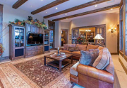 Spacious Family Room featuring a stone fireplace and access to hot tub deck | Tahoe Ski Resort Real Estate