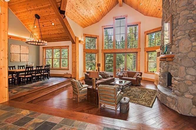 Grand Living Room with Vaulted Ceilings and Floor to Ceiling Stone Fireplace