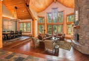 Grand Living Room with Vaulted Ceilings and Floor to Ceiling Stone Fireplace