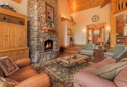 Grand Living Room with Vaulted Ceilings and Floor to Ceiling Stone Fireplace