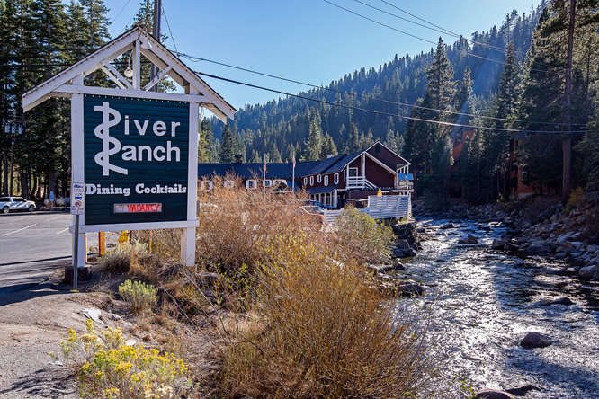 image of River Ranch sign next to river for The Iconic River Ranch Restaurant & Lodge Is For Sale