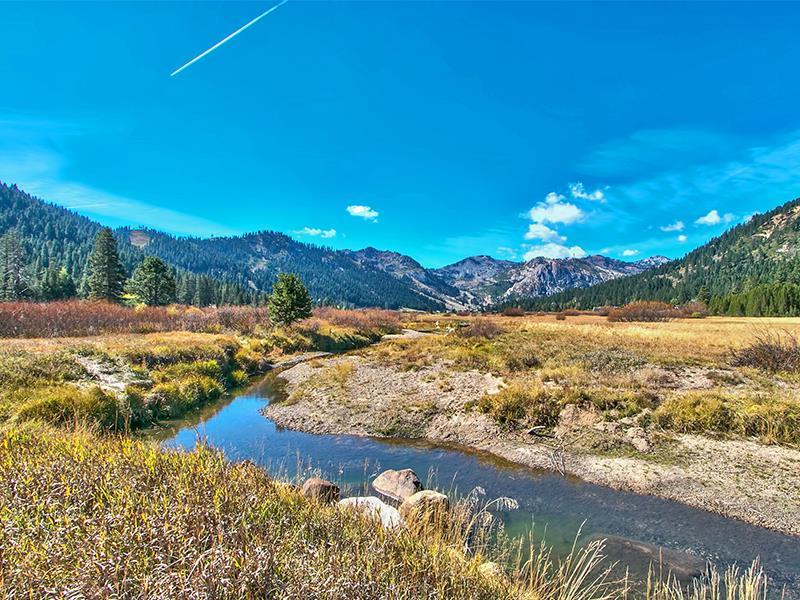 325 Squaw Valley Rd | Squaw Valley home for sale image, stream with mountains behind